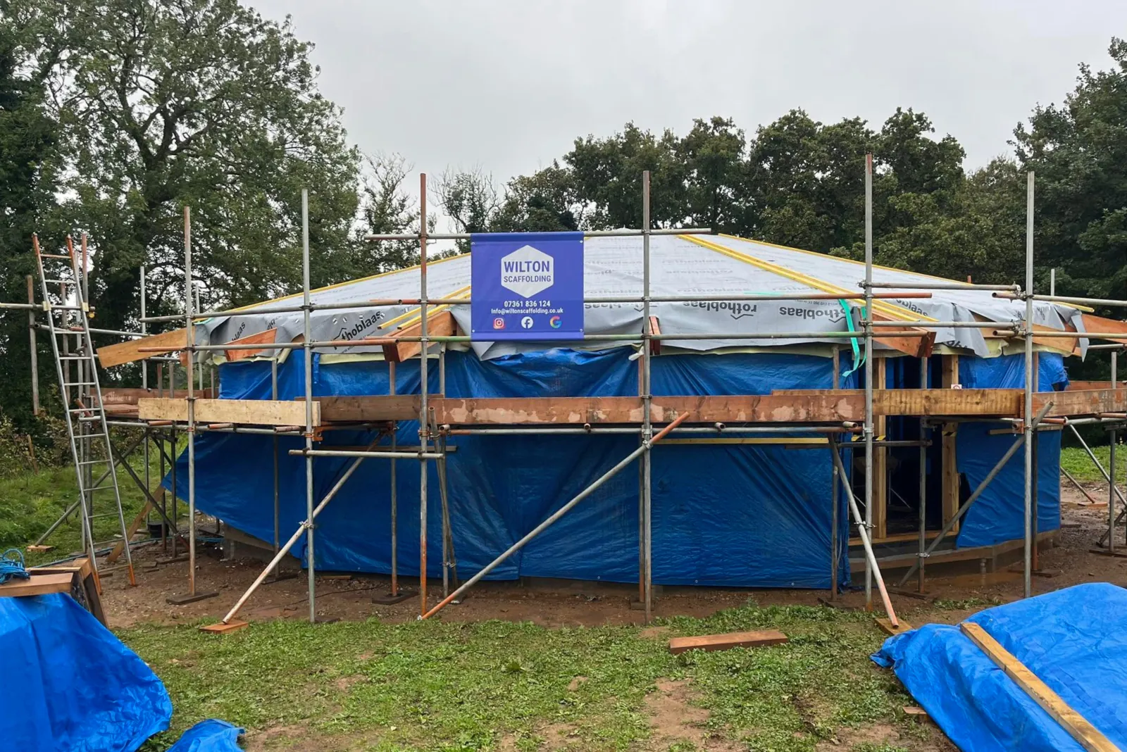 Scaffolding around timber lodge style yoga studio.